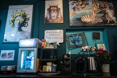 a room with posters on the wall and a counter at Brix Hostel in Prague