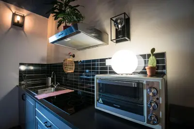 a kitchen with a microwave and a sink at Brix Hostel in Prague
