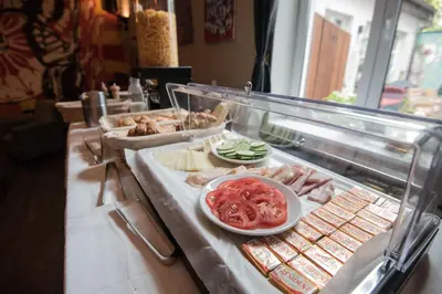 a buffet line with different types of food on display at Brix Hostel in Prague