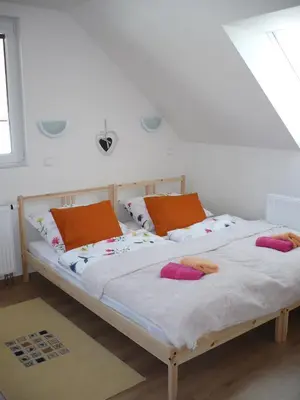 two beds with pillows on them in a bedroom at Rivendell Apartments in Prague