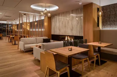 a restaurant with tables and couches and chairs at Hotel Osvit in Mladá Boleslav