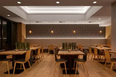 a dining room with wooden tables and chairs at Hotel Osvit in Mladá Boleslav