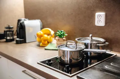 two pots and pans on a stove in a kitchen at Lovely Prague Havanska - with Free Parking in Prague