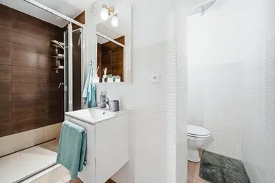 a white bathroom with a sink and a toilet at Lovely Prague Havanska - with Free Parking in Prague