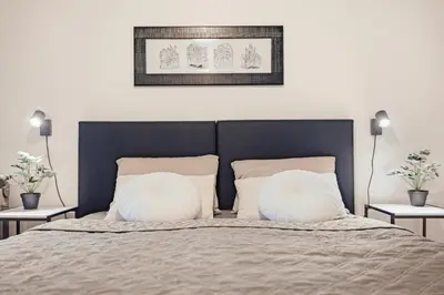 a bedroom with a bed with two pillows at Lovely Prague Havanska - with Free Parking in Prague