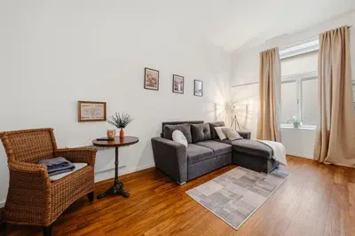 a living room with a couch and a chair at Lovely Prague Havanska - with Free Parking in Prague