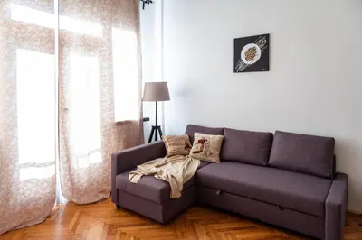 a living room with a purple couch and a window at Stunning Design Apartment in Prague