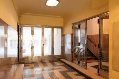 an empty hallway with glass doors in a building at Stunning Design Apartment in Prague