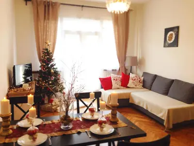 a living room with a couch and a christmas tree at Stunning Design Apartment in Prague