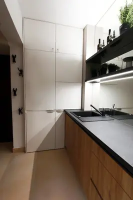 a kitchen with white cabinets and a sink at Brunetti Design Apartment in Prague