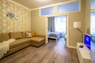 a living room with a couch and a bedroom at Old Town Rybna Apt by Ruterra in Prague