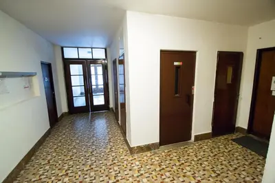 an empty hallway with two doors and a tile floor at Old Town Rybna Apt by Ruterra in Prague