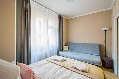 a small bedroom with a bed and a window at Old Town Rybna Apt by Ruterra in Prague