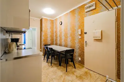 a kitchen with a table and chairs in a room at Old Town Rybna Apt by Ruterra in Prague