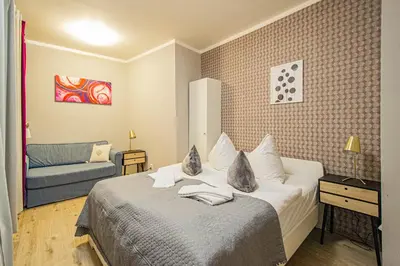 a hotel room with a bed and a couch at Old Town Rybna Apt by Ruterra in Prague