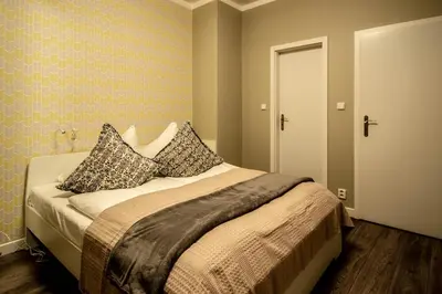 a bedroom with a bed with pillows on it at Old Town Rybna Apt by Ruterra in Prague