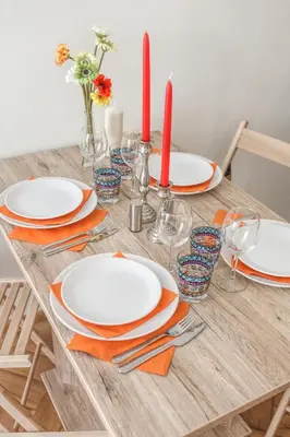 a dining room table with plates and red candles at Modern Apartment Zitna in Prague