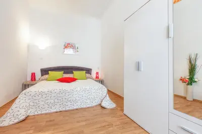 a bedroom with a bed with yellow and red pillows at Modern Apartment Zitna in Prague