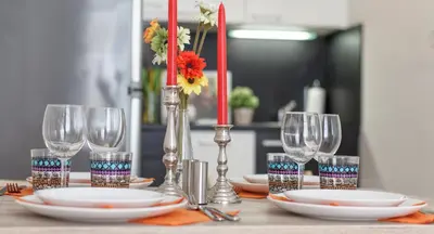 a table with plates and wine glasses on it at Modern Apartment Zitna in Prague
