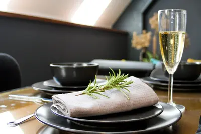 a table with a glass of wine and a napkin at Royal Apartmány in Dobříš