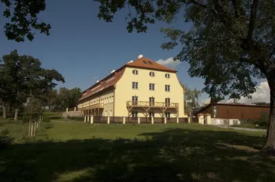 a large white building with a red roof at Royal Apartmány in Dobříš