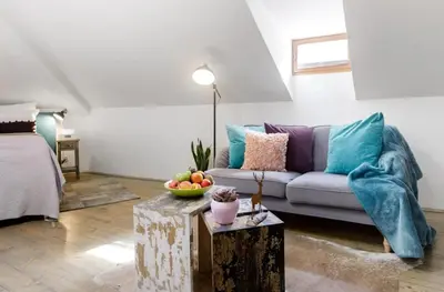 a living room with a couch and a table at Romantic Bohemian Studio in Old Town Prague in Prague