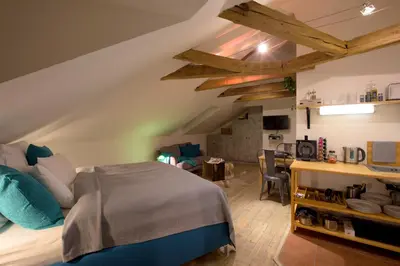 a bedroom with a bed and a dining room at Romantic Bohemian Studio in Old Town Prague in Prague