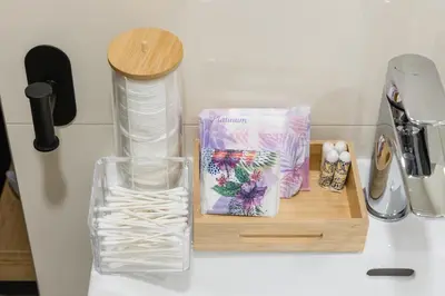 a counter top with a cutting board with a bottle and a glass at Romantic Bohemian Studio in Old Town Prague in Prague