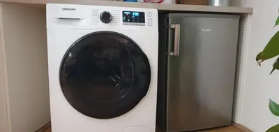 a white washing machine next to a refrigerator at Romantic Bohemian Studio in Old Town Prague in Prague