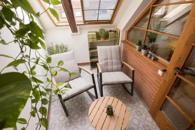 a tiny house with two chairs and a table at Bohemian Chic 2 Bedroom 2 Bathroom Loft with Hanging Chair in Prague