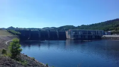 a large dam on a river with water at Penzion Paták in Kamýk nad Vltavou