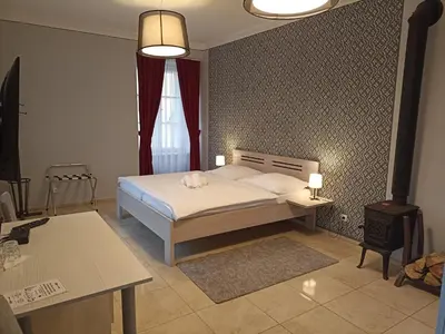 a bedroom with a white bed and a window at Penzion U tri statkaru in Dobříš