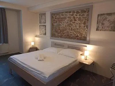 a bedroom with a bed with two towels on it at Penzion U tri statkaru in Dobříš