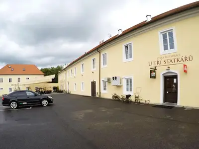 a car parked in a parking lot in front of a building at Penzion U tri statkaru in Dobříš