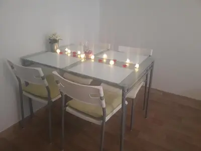 a dining room table with chairs and lights on it at Apartmány Karlštejn in Karlštejn