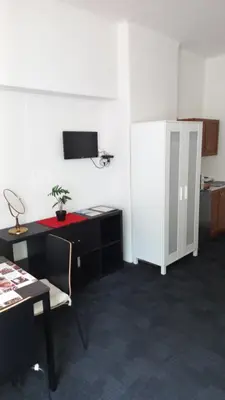 an office with a desk and a white refrigerator at Apartmány Karlštejn in Karlštejn
