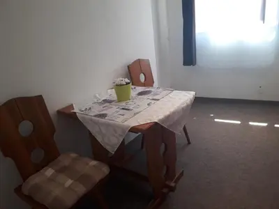 a table and two chairs with a table and a vase on it at Apartmány Karlštejn in Karlštejn