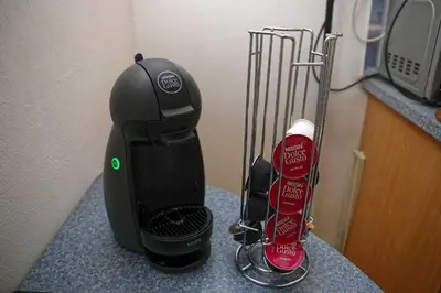 a coffee maker on a counter with a bottle of coffee at Apartments Truhlarska 31 in Prague