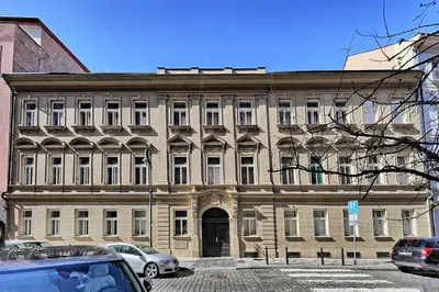 a large tan building with a large doorway at Apartments Truhlarska 31 in Prague