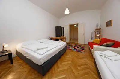 a bedroom with a large bed and a couch at Apartments Truhlarska 31 in Prague