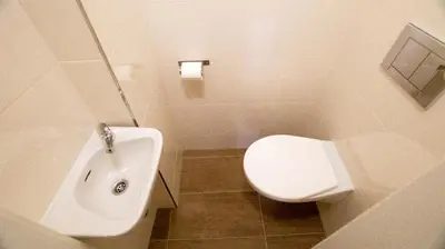 a bathroom with a white toilet and a sink at Apartment by the Old Town Square in Prague