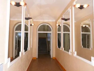 a hallway of a house with windows and a staircase at Apartment by the Old Town Square in Prague