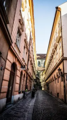 a cobblestone street in an alley between buildings at Apartment by the Old Town Square in Prague