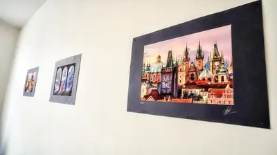 a picture on a wall with two pictures on it at Apartment by the Old Town Square in Prague
