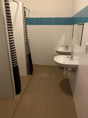 a bathroom with two sinks and a shower at Easy Housing in Prague