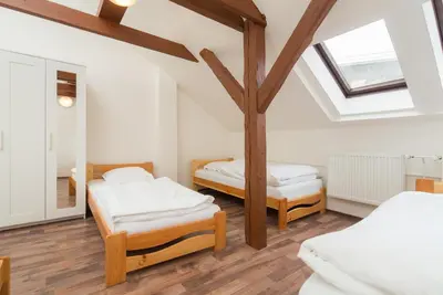 a bedroom with two beds and a skylight at Easy Housing in Prague