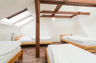 a room with three beds and a vaulted ceilings at Easy Housing in Prague
