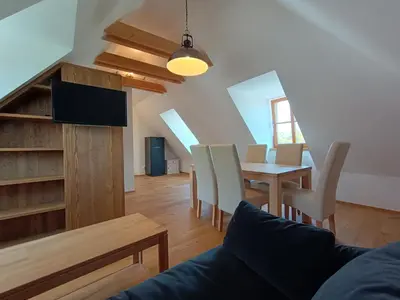 a living room with a table and a dining room at Apartmány Malý mnich in Mníšek pod Brdy