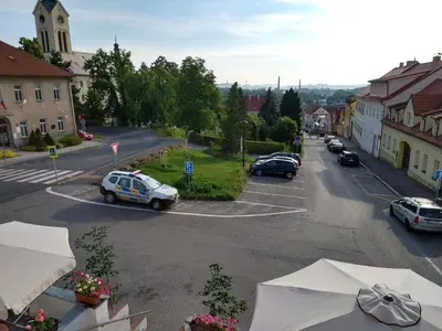 a police car is parked in a parking lot at Apartmány Malý mnich in Mníšek pod Brdy