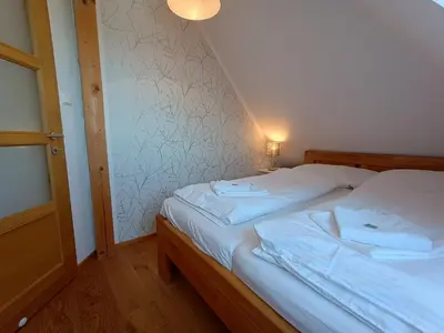 a bedroom with two beds with towels on them at Apartmány Malý mnich in Mníšek pod Brdy